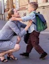 Woman hugging boy with backpack